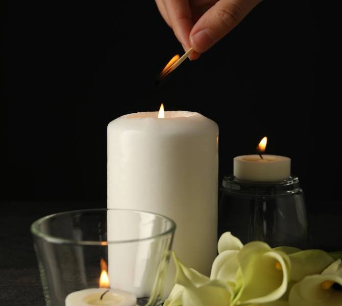 Lighting the fire of the candle of mourning.