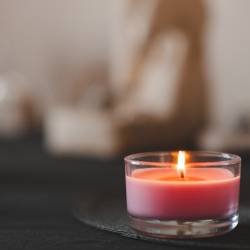 Scented candle in dark room at home